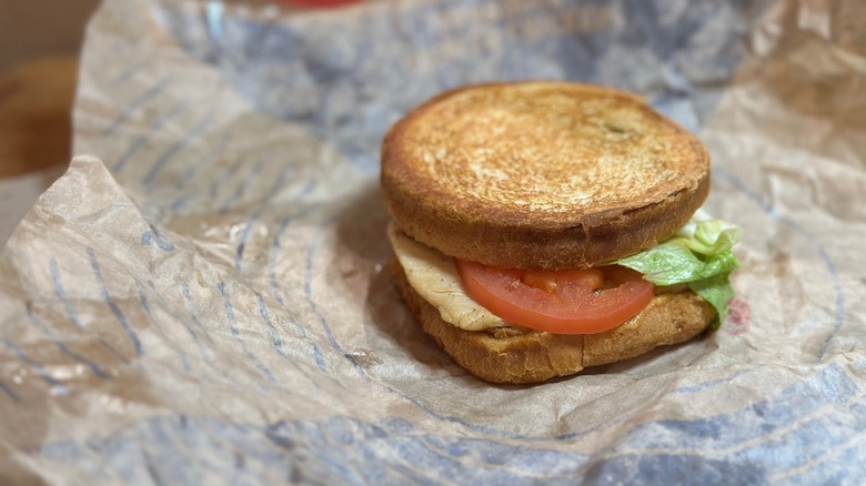 A Jack in the Box Sourdough Grilled Chicken Sandwich on foil paper