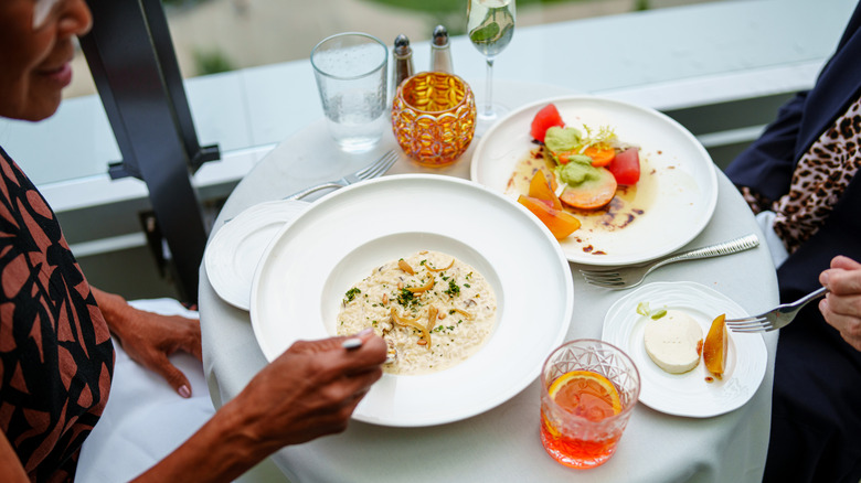 Two women eat at an upscale restaurant