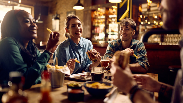 Group of people eating and talking at a restaurant