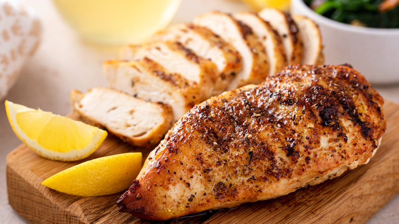 Roasted meat and lemon wedges