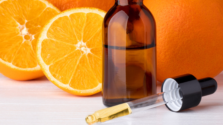 Sliced oranges and jar of citrus extract