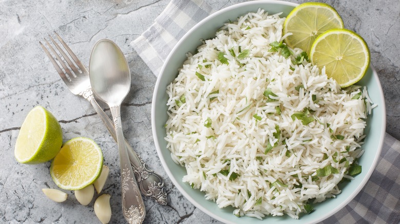 Bowl of white rice and sliced limes