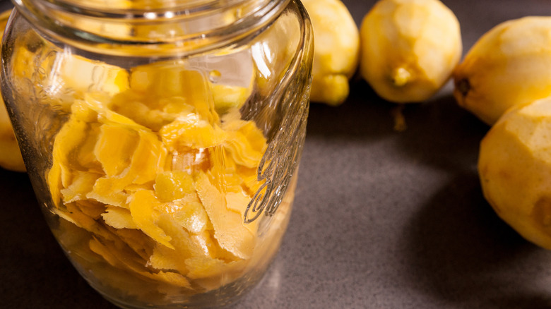 A mason jar with lemons and peels