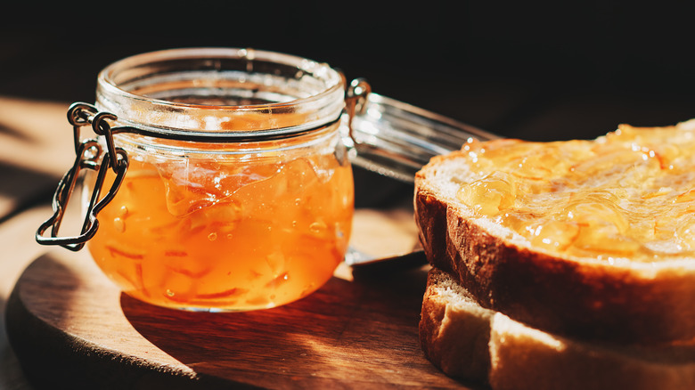 Orange marmalade in a jar and toast