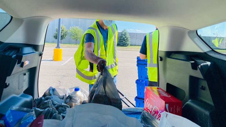 Grocery employee loading bags for a pickup order