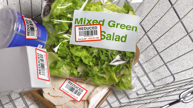 Grocery items with reduced sales stickers in cart