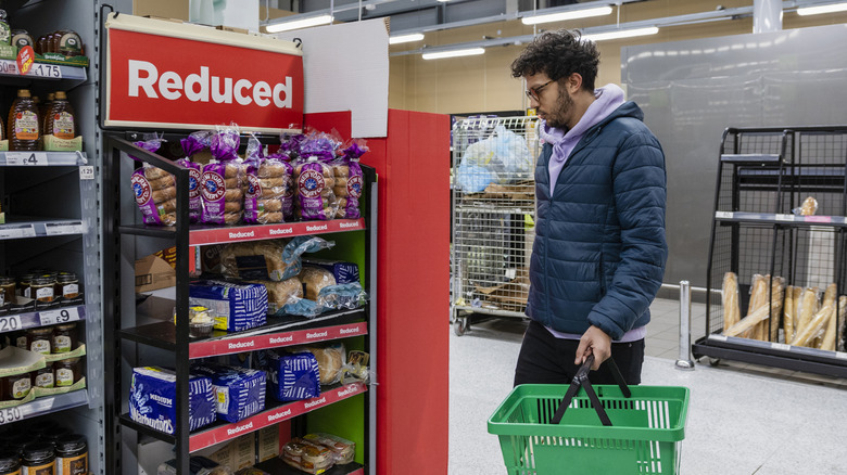Man browsing sale items at a grocery store