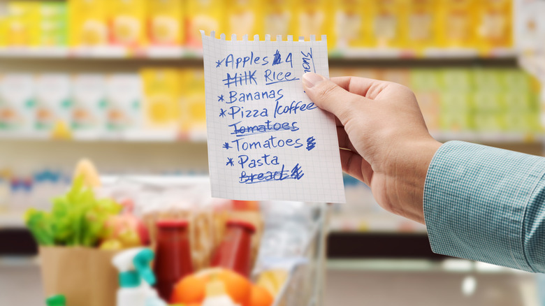 Woman at store with grocery list