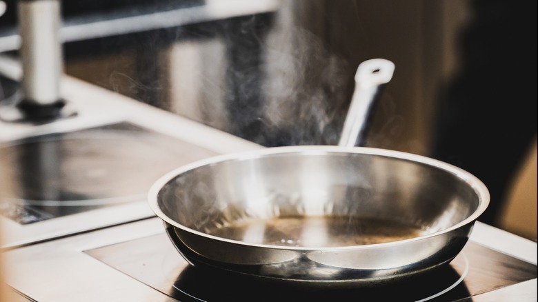 sauteeing shot of a pan with steam rising, from a distance