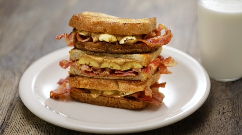 "Elvis Presley's favorite sandwich. Peanut Butter, bananas and bacon on white bread - grilled in butter beside a glass of milk
