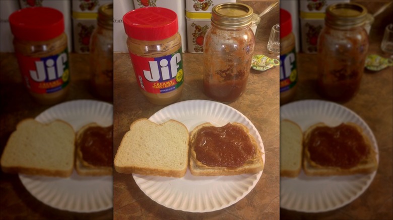 Peanut Butter and Apple Butter sandwich open on paper plate with Jif peanut butter jar and apple butter glass jar behind it