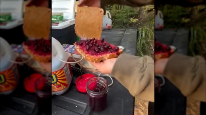 woman making a Peanut Butter and Huckleberry sandwich using fresh huckleberries and huckleberry jam