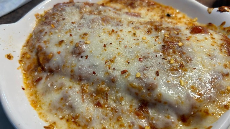 Close up slice of Fazoli's Baked Lasagna on a white plate
