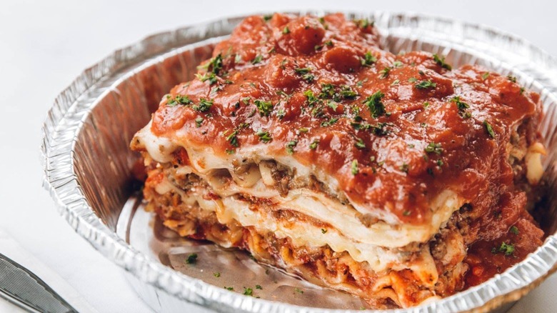 Slice of The Old Spaghetti Factory Lasagna in aluminum takeaway container