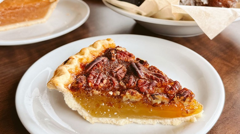 Denny's pecan pie on a white plate