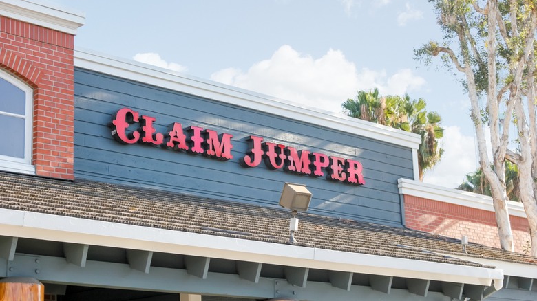 Claim Jumper restaurant exterior with red logo on wall