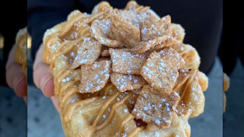 Close up of waffle from Dolly Llama topped with drizzle and cinnamon toast crunch