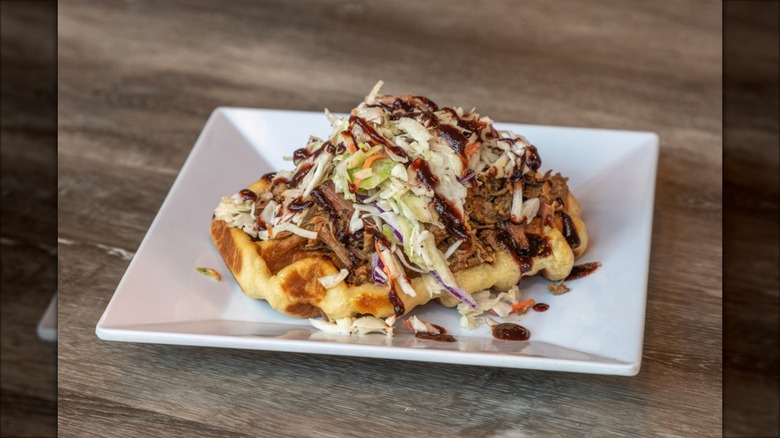 Pulled pork waffle topped with coleslaw with  at Waffle Window on plate