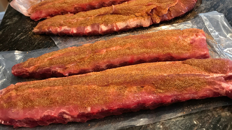 Racks of ribs coated in a dry rub