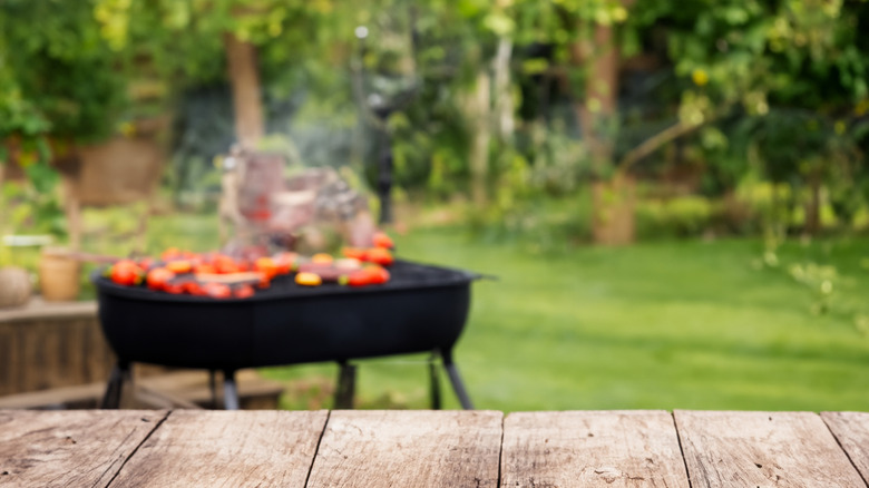 Food being cooked on a grill in a garden