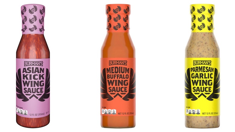 Three bottles of Burman's wing sauces in Asian Kick, Medium Buffalo, and Parmesan Garlic flavors on a white background.
