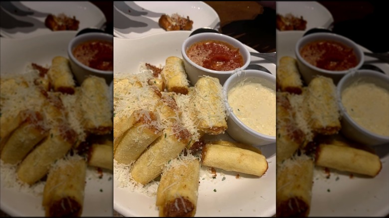 An order of stuffed ziti fritta at Olive Garden with sauces on the side, mirrored