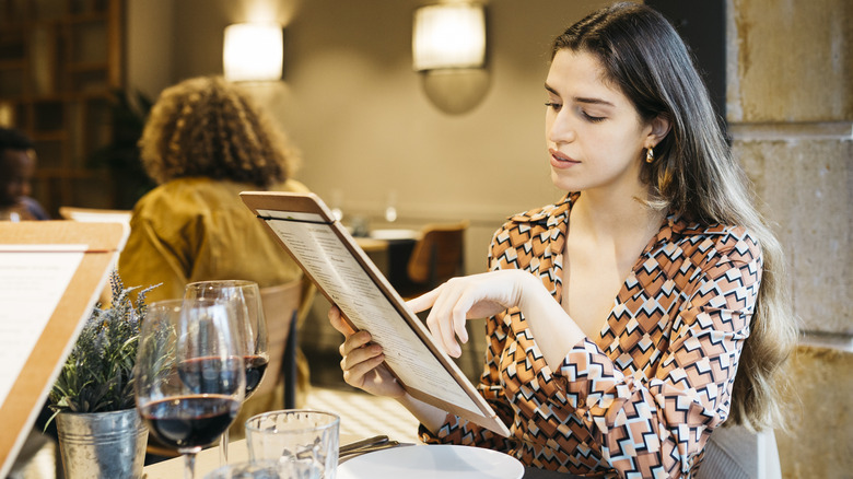 Restaurant patron reading a menu