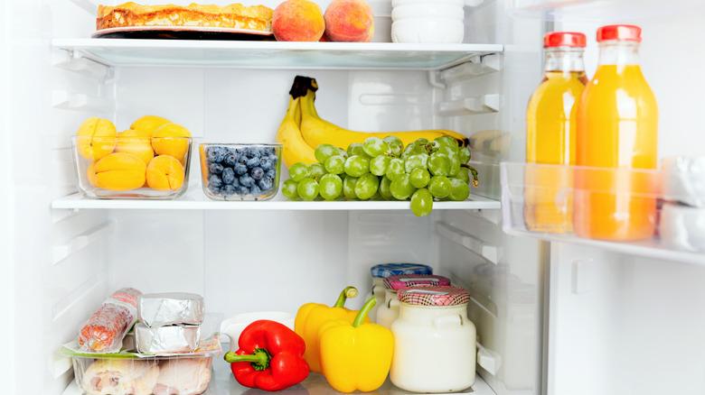 Open refrigerator filled with fresh produce