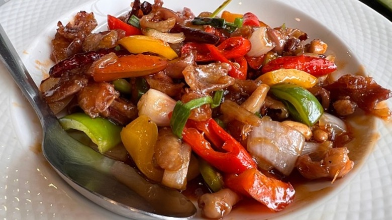 stir fry with veggies in white bowl with spoon