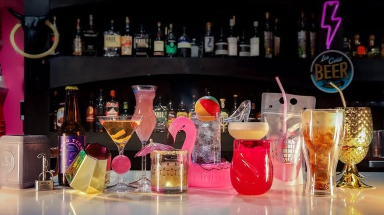 Allusion interior bar lined with specialty cocktail drinks for Barbie theme