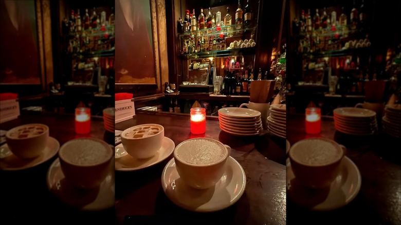 The Back Room speakeasy bar with low lighting and drinks in tea cups
