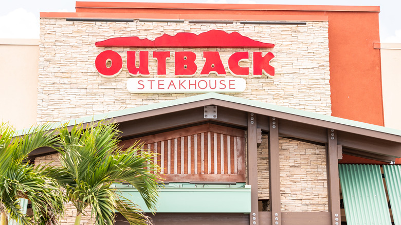 Outback Steakhouse sign on stone storefront