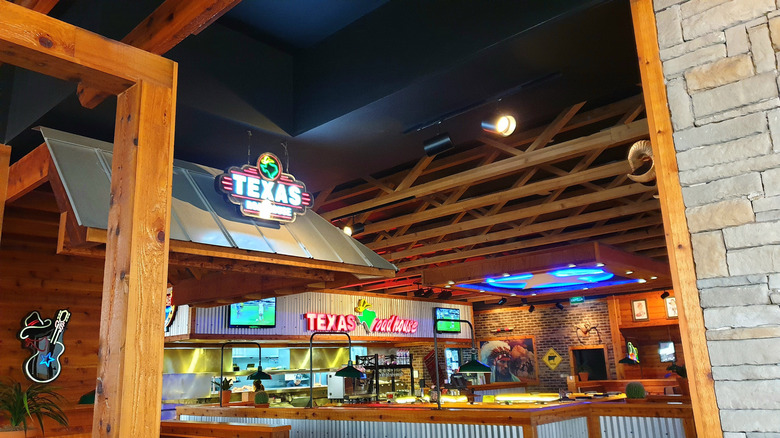 Texas Roadhouse restaurant interior with neon signs