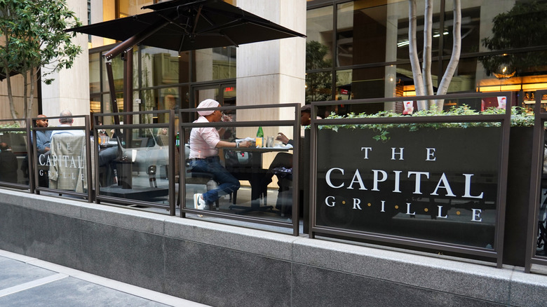 Customers dining on terrace of The Capital Grille