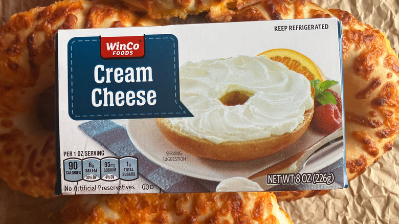 close up top view of a box of WinCo cream cheese placed on top of cheese bagels