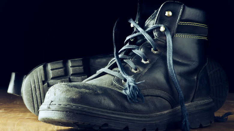 A pair of black steel-toed boots on the floor
