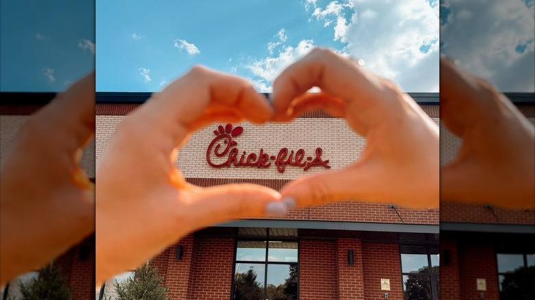 Hands forming a heart around the Chick-fil-A sign