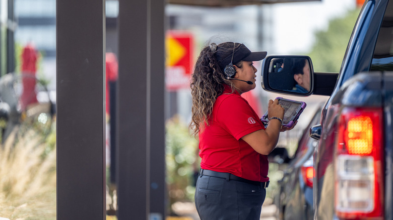 Woman taking order in Chick-fil-A drive-thru