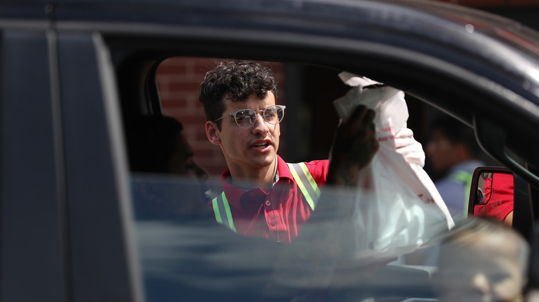 Chick-fil-A worker handing customer a bag