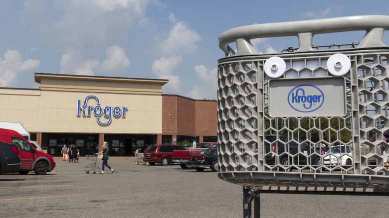 A Kroger store in the background, a Kroger cart in the foreground
