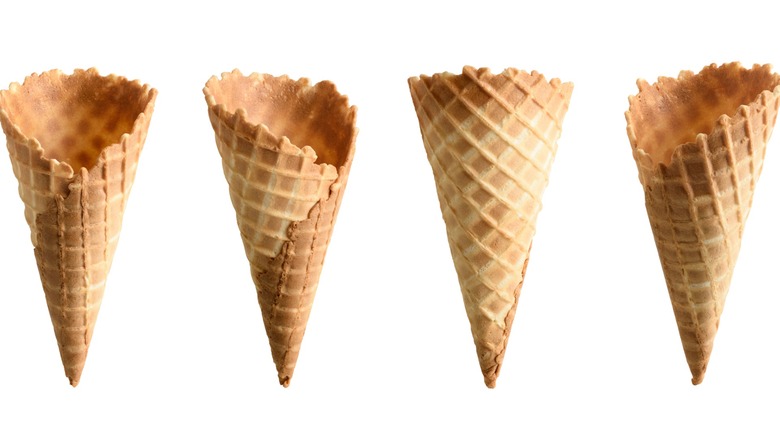 Four waffle cones for ice cream on a white background