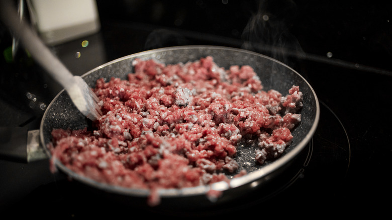 Ground beef cooking in a pan