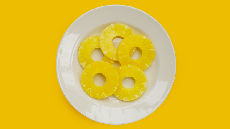 Canned pineapple rings on a white plate
