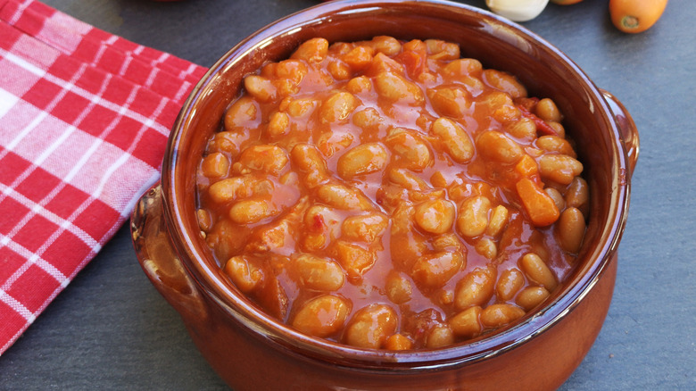 A brown crock of baked beans