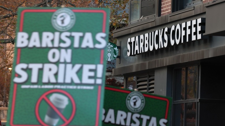 Starbucks signs held at a picket line at a strike outside a Starbucks store