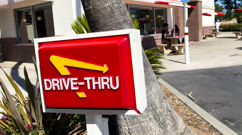 A close-up of the red and yellow In-N-Out drive-thru sign.