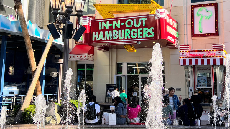 The storefront of IN-N-Out in Las Vegas, with several people clustered outside.