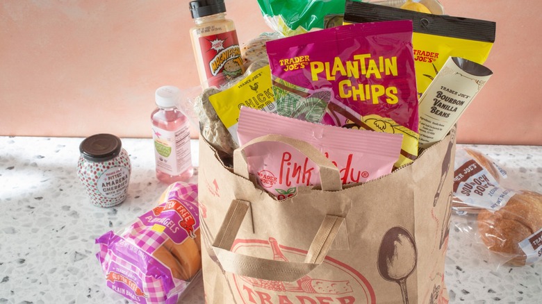 A view of a Trader Joe's shopping bag full of their brand groceries