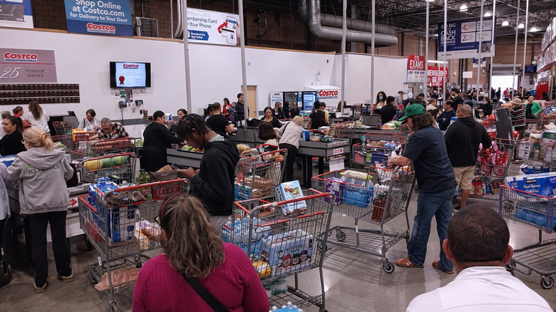 Long lines crowd the Costco checkout area.
