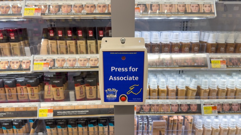 Press for Associate button on locked merchandise inside a Walmart grocery store.